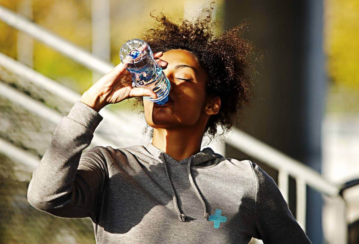 Healthy Woman Drinking Water - SOS Hydration